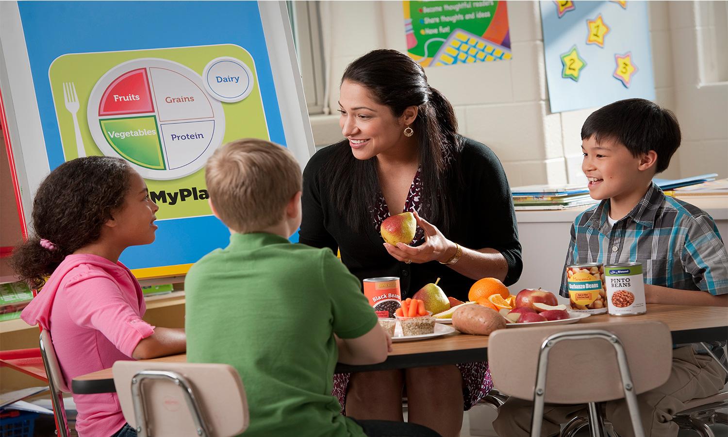Profesora hablando sobre comida sana con niños